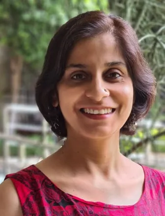 Karla Legg, a Holistic Sleep Coach, smiling.