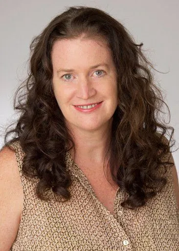 Rachael Taylor, a Holistic Sleep Coach, smiling.